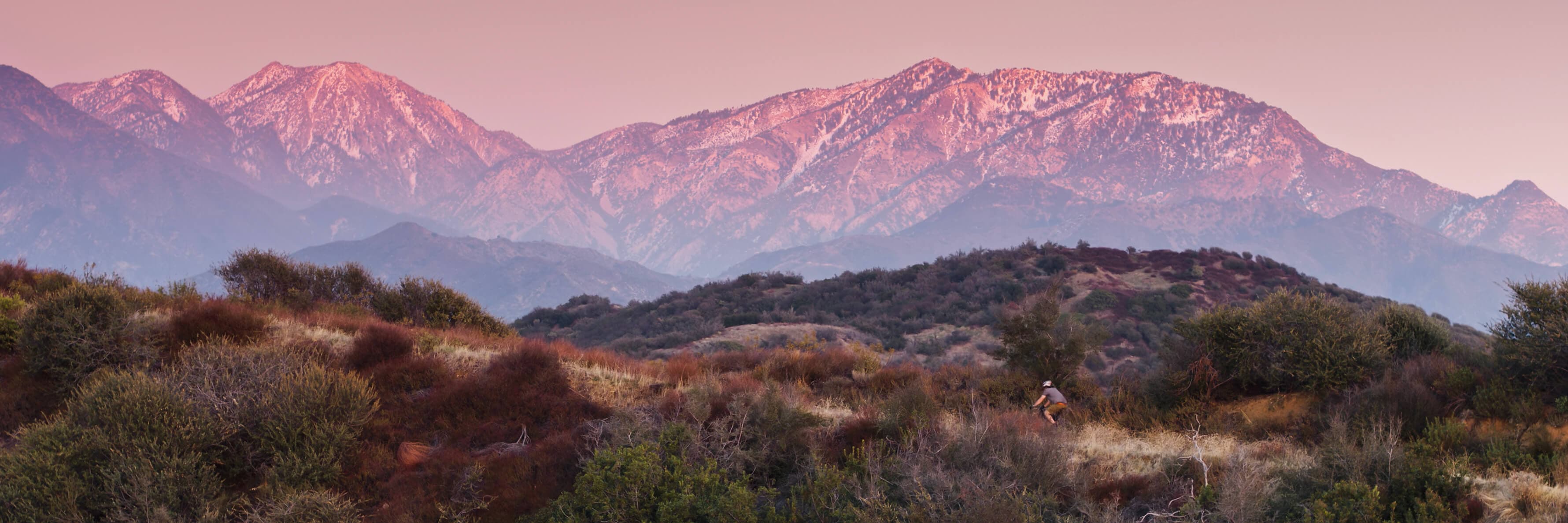 Drone shot of a lone male cyclist on a dirt trail off of Glendora Mountain Road in the San Gabriel Mountains of Southern California.